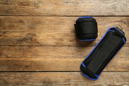 Blue weighting agents on wooden table, flat lay. Space for text
