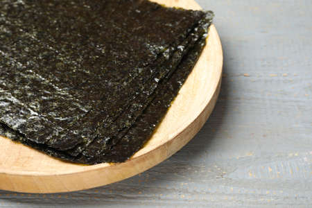 Dry nori sheets on gray wooden table, closeupの写真素材