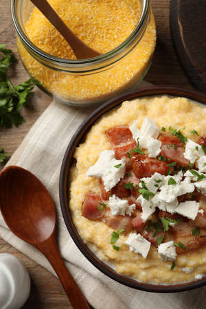Delicious traditional Ukrainian banosh served on wooden table, flat layの写真素材