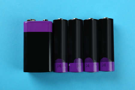 Different batteries on turquoise background, flat layの写真素材