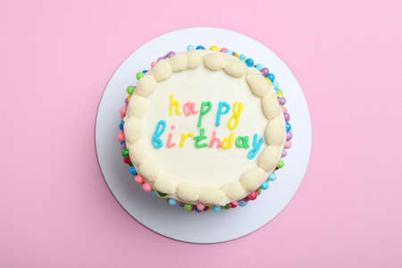 Cute bento cake with tasty cream on pink background, top view