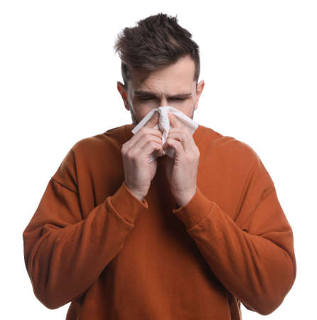Sick man sneezing on white background. cold symptomsの写真素材