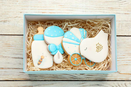 Set of baby shower cookies in gift box on white wooden table, top viewの写真素材