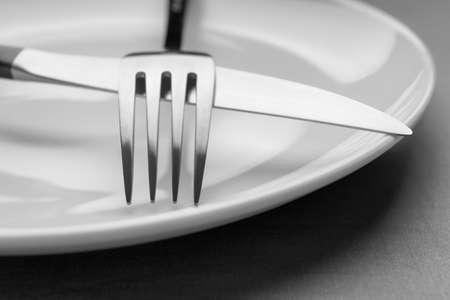 Plate with shiny silver cutlery on gray table, closeupの写真素材