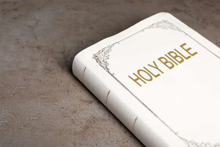 Bible with white cover on light gray table, closeupの写真素材