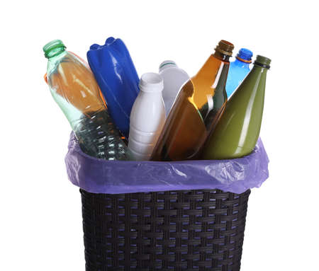 Trash bin full of plastic bottles on white background, closeup. Recycling rubbishの写真素材