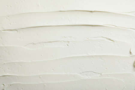 Closeup of tasty cream cheese as background, top view