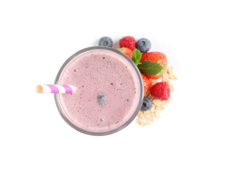 Glass of tasty smoothie with berries, mint and oatmeal on white background, top viewの写真素材