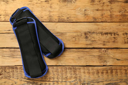 Blue weighting agents on wooden table, flat lay. Space for text