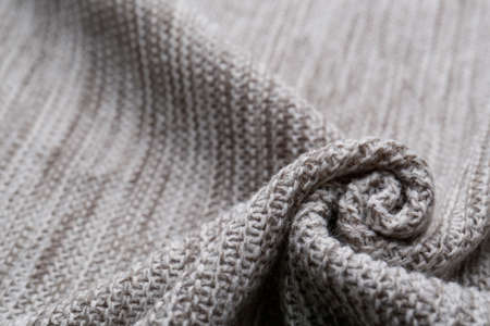 Beautiful gray knitted fabric as background, closeup