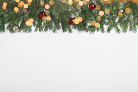 Flat lay composition with fir tree branches and Christmas decor on white background, space for text....
