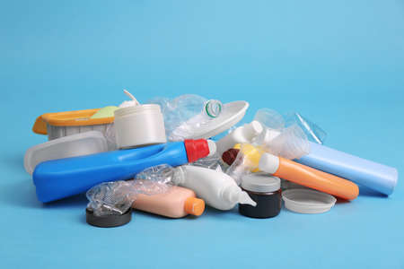 Pile of plastic garbage on light blue background