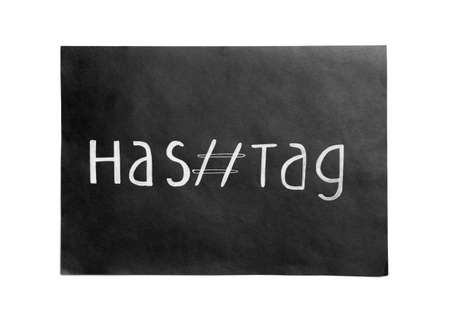 Black paper with word Hashtag and symbol on white background, top viewの写真素材