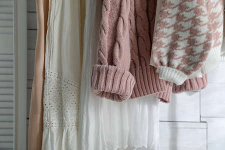 Different stylish clothes near white wall in room, closeupの写真素材