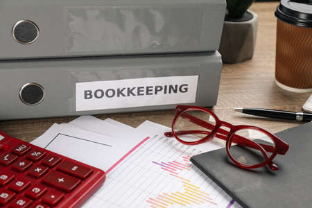 Bookkeeper's workplace with folders and documents on tableの写真素材