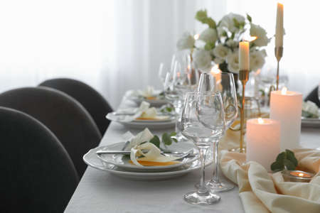 Festive table setting with beautiful floral decor in restaurant, space for textの写真素材