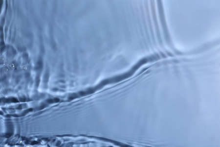 Close up view of water with rippled surface on blue background
