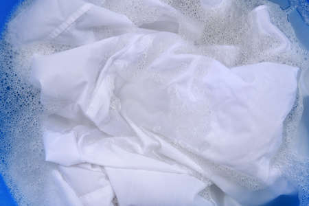 White garment in suds, closeup. hand washing laundryの写真素材