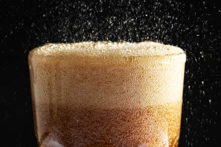 Glass of refreshing soda drink on black background, closeupの写真素材