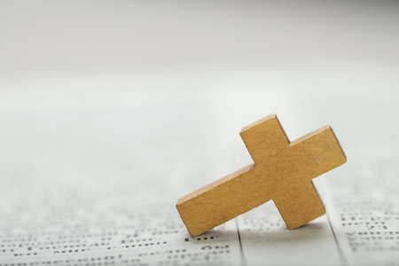 Christian cross on Bible, closeup. Space for textの写真素材