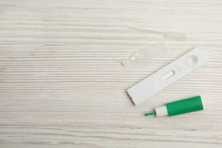 Disposable express hepatitis test kit on white wooden table, flat lay. Space for textの写真素材