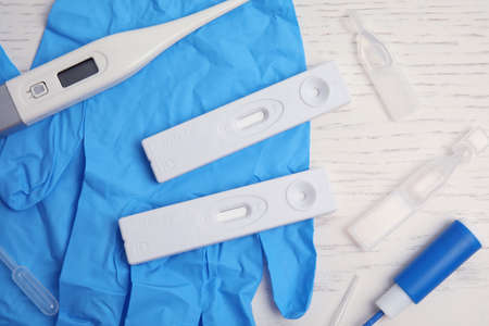 Disposable express test kit for hepatitis on white wooden table, flat layの写真素材