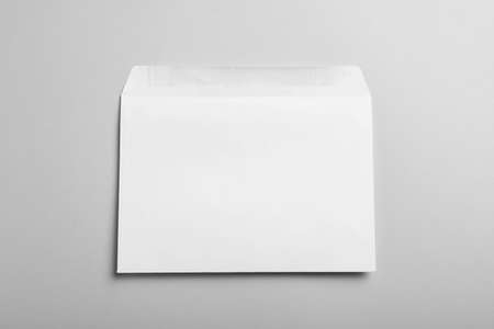 White paper envelope on light gray background, top view