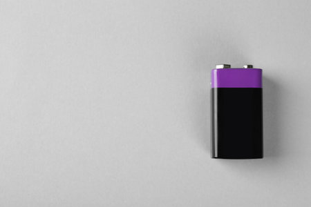 New nine volt battery on light gray background, top view. Space for textの写真素材