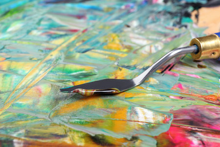 Abstract colorful acrylic paint and spatula, closeup viewの写真素材