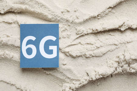 6G technology, Internet concept. Card on white sand, top view. Space for textの写真素材