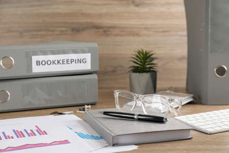 Bookkeeper's workplace with folders and documents on tableの写真素材