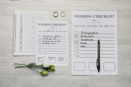 Flat lay composition with Wedding Checklists and calendar on white wooden tableの写真素材