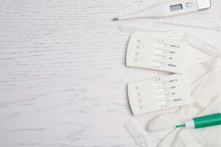 Disposable express hepatitis test kit on white wooden table, flat lay. Space for textの写真素材