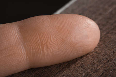 Close up view of human finger on wooden surfaceの写真素材