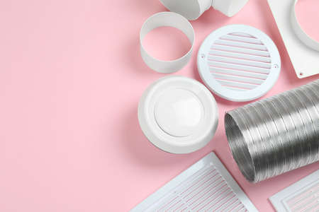 Parts of home ventilation system on pink background, above view. Space for text