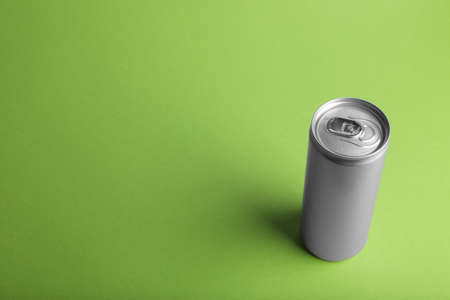 Can of energy drink on light green background. Space for textの写真素材