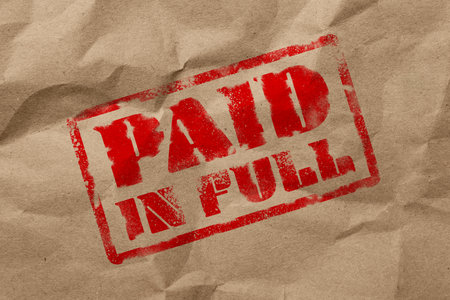 Crumpled kraft paper with stamp PAID IN FULL, top viewの写真素材