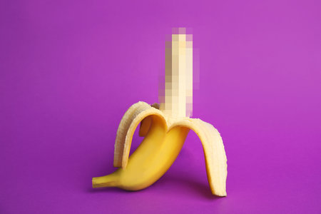 Fresh banana on purple background. sex conceptの写真素材