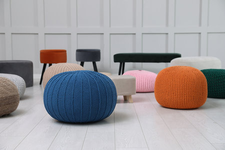 Different stylish poufs and ottomans in roomの写真素材