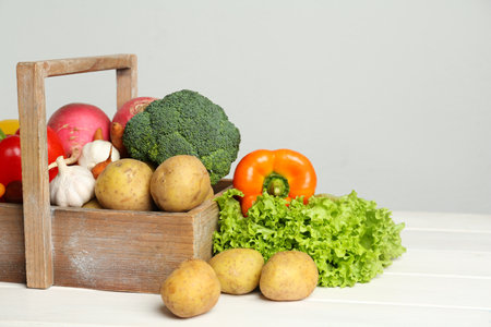 Assortment of fresh vegetables on white wooden tableの写真素材