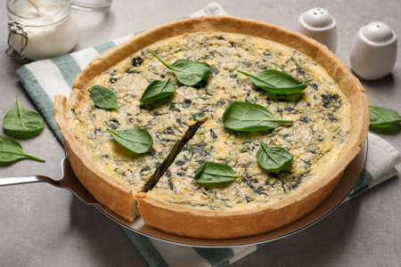 Fresh delicious homemade spinach pie on gray tableの写真素材