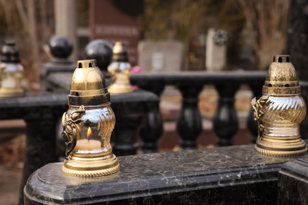 Grave lanterns on granite surface at cemeteryの写真素材