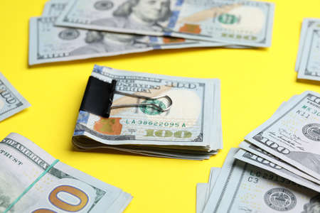 Dollar banknotes with paper clip on yellow background, closeupの写真素材