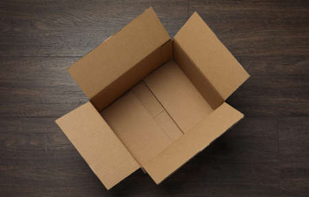 Empty open cardboard box on wooden table, top viewの写真素材