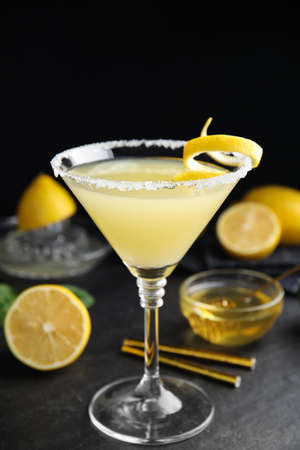 Delicious bee's knees cocktail and ingredients on black tableの写真素材