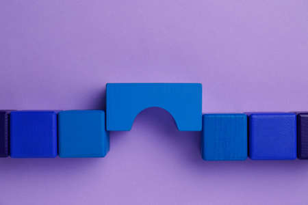 Bridge made of colorful blocks on violet background, flat lay. Connection, relationships and deal conceptの写真素材