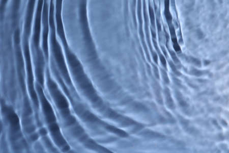 Close up view of water with rippled surface on blue backgroundの写真素材