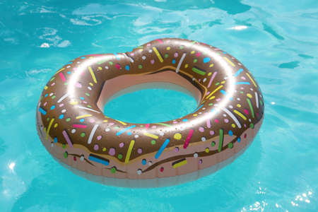 Inflatable ring floating on water in swimming poolの写真素材
