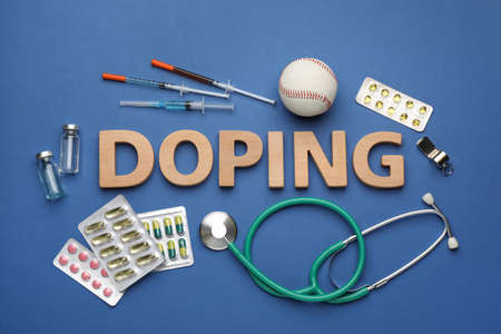 Flat lay composition with word Doping, baseball ball and drugs on blue backgroundの写真素材