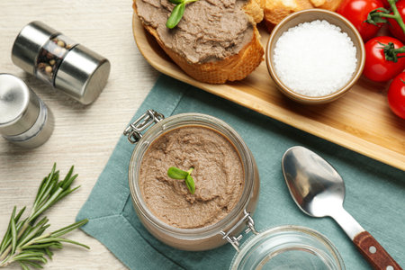 Flat lay composition with delicious liver pate on white wooden table